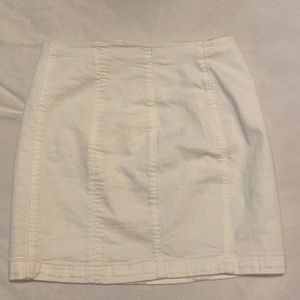 white denim material skirt. not very flowy, but fitting.